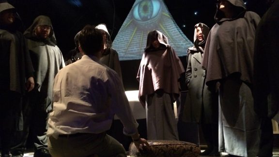 Oliver Senton as Robert Anton Wilson surrounded by Illuminati , taken by Adam Clark